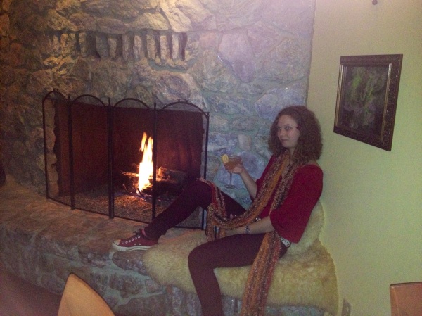 Drinking by the fireplace.